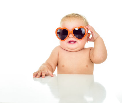 Beautiful smiling baby in sunglasses. One, isolated on white.