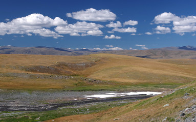 Fototapeta na wymiar Valley of the mountain river with snow on the high plateau near Mongolia, Plateau Ukok, Altai mountains, Siberia, Russia