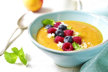 Peach smoothie  bowl on a light background.
