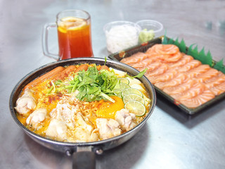 noodle in spicy milk curry soup and salmon with blur background.