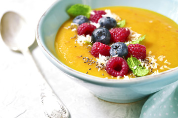 Peach smoothie  bowl on a light background.