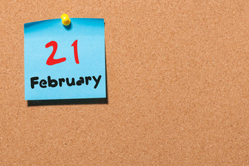 February 21st. Day 21 of month, calendar on cork notice board background. Winter time. Empty space...