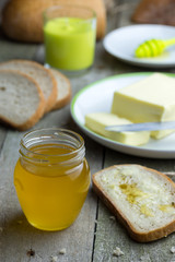 Honey in glass jar on wooden table.