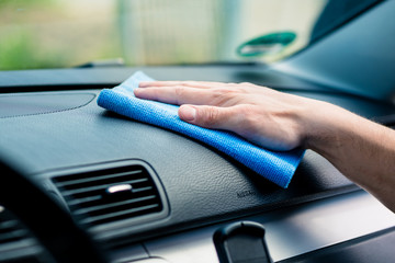 Man wiping the dashboard of his car