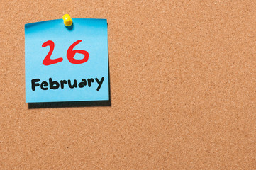 February 26th. Day 26 of month, calendar on cork notice board background. Winter time. Empty space...