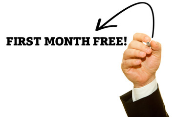 Businessman Hand Writing a message, First Month Free.
