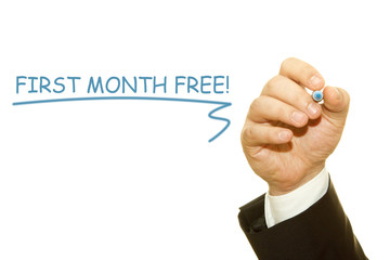 Businessman Hand Writing a message,  First Month Free.