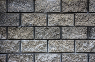 Gray wall of granite bricks texture background