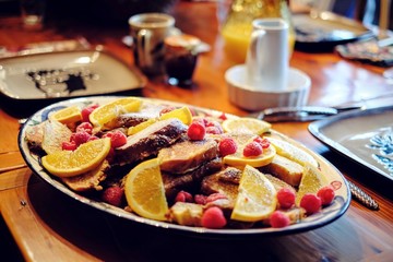 Family Style French Toast Platter with orange and raspberries to