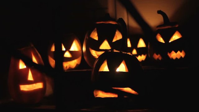 group of glowing pumpkins at night