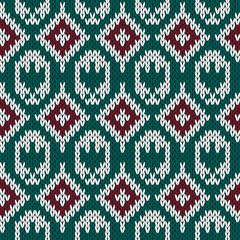 Knitting ornate seamless pattern in red, green and white colors