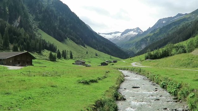 Zillertal valley landscape with meadow, barn and stream. Located at Schoenachtal valley in Tirol (Austria).