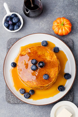 Pumpkin pancakes with maple syrup Top view
