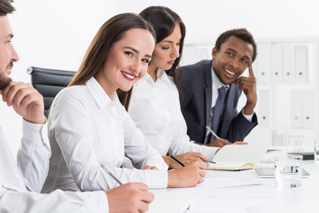 Fototapeta premium Portrait of four smiling business people
