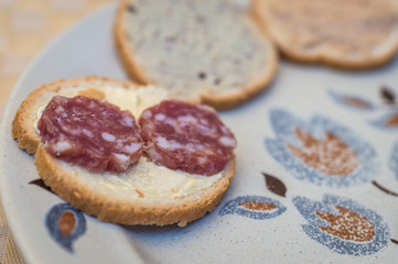 sandwich with sliced sausage on the plate