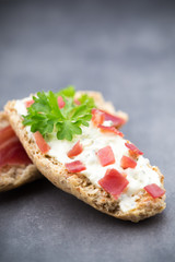 Crispbread with soft cheese with herbs and bacon.