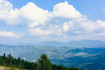 Carpathian Mountains in Summer. Beautiful nature landscape with mountains, trees and blue sky with clouds