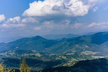 Carpathian Mountains in Summer. Beautiful nature landscape with mountains, trees and blue sky with clouds