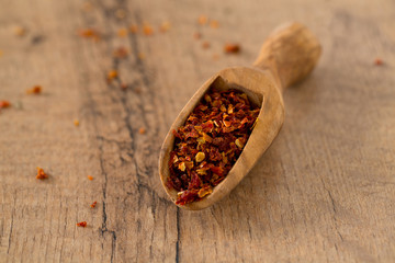 dried tomatoes as spice in a wooden scoop