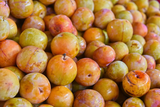 Fresh organic plums on street market stall