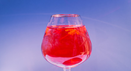 Wine glass filled with red and yellow ink