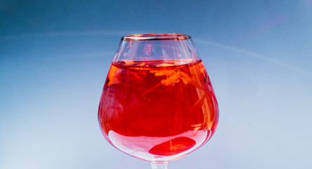 Wine glass filled with red and yellow ink