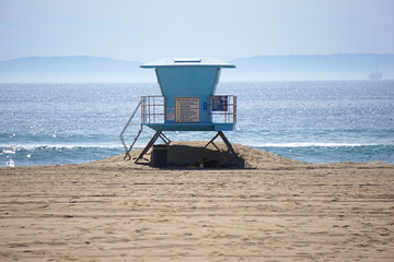 blue lifeguard stand on beach