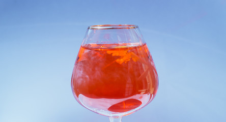 Wine glass filled with red and yellow ink