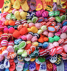 Fototapeta na wymiar Pile of handmade woolen gloves at Riga Christmas market