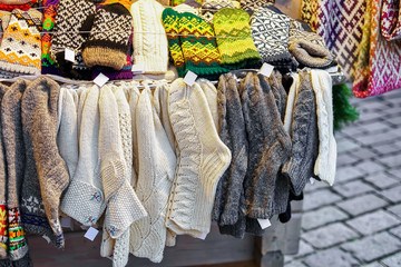 White and gray woolen socks hanging at Riga Christmas market