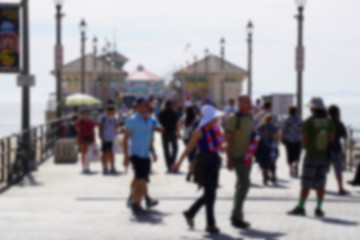 blur background of people walking on ocean pier