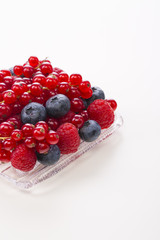 border of fresh berries with green, leaves isolated