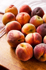 Sweet ripe peaches on a wooden table