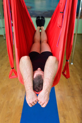 Aerial Yoga, man relaxing in hammock