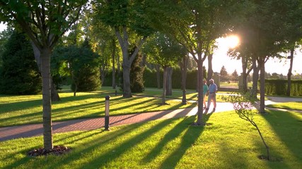 Senior couple walks on alley. Elderly people outdoors. We live a full life. Stay together and save love.