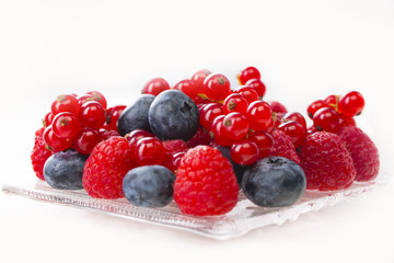 border of fresh berries with green, leaves isolated