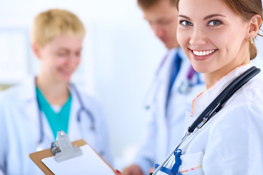Attractive female doctor in front of medical group