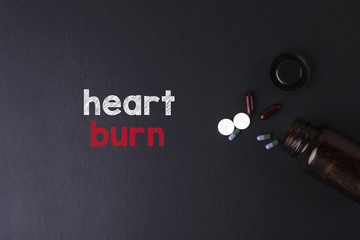 Heart Burn word with medicine and bottle - Health concept. Medical concept