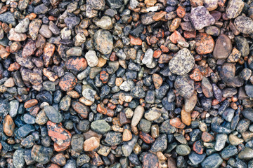 Abstract background with decorative floor pattern of wet sea gravel stones, Gravel texture