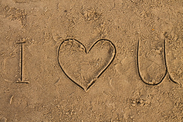 I Love U sign on the wet sand beach