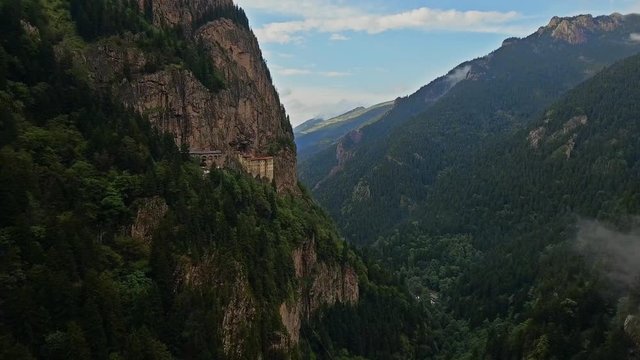 4K UHD Aerial Video of Extraordinary Hanging Mountain Monastery. The Sumela Monastery is a Greek Orthodox monastery dedicated to the Virgin Mary at Mel&aacute; Mountain within the Pontic Mountains range.