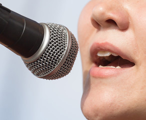 girl singing into a microphone