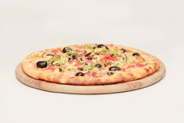 Tasty pizza with vegetables, chicken and olives