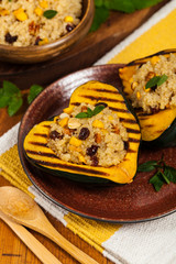 Pumpkin Acorn Stuffed with Quinoa, Nuts and Dried Fruit. Selective focus.