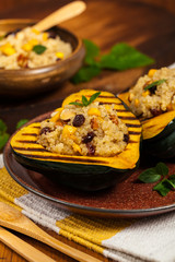 Pumpkin Acorn Stuffed with Quinoa, Nuts and Dried Fruit. Selective focus.