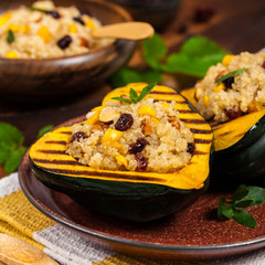 Pumpkin Acorn Stuffed with Quinoa, Nuts and Dried Fruit. Selective focus.
