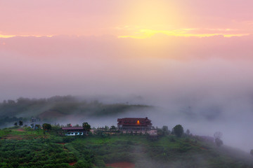 Fototapeta premium Sunny sunrise in a beautiful countryside. Gentle fog above villa