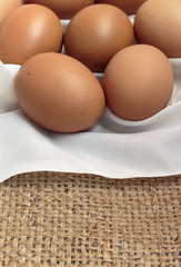 chicken eggs on brown sacking. over light and retro tone [blur and select focus background]