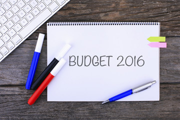 Notebook with BUDGET 2016 Handwritten on wooden background and Modern keyboard