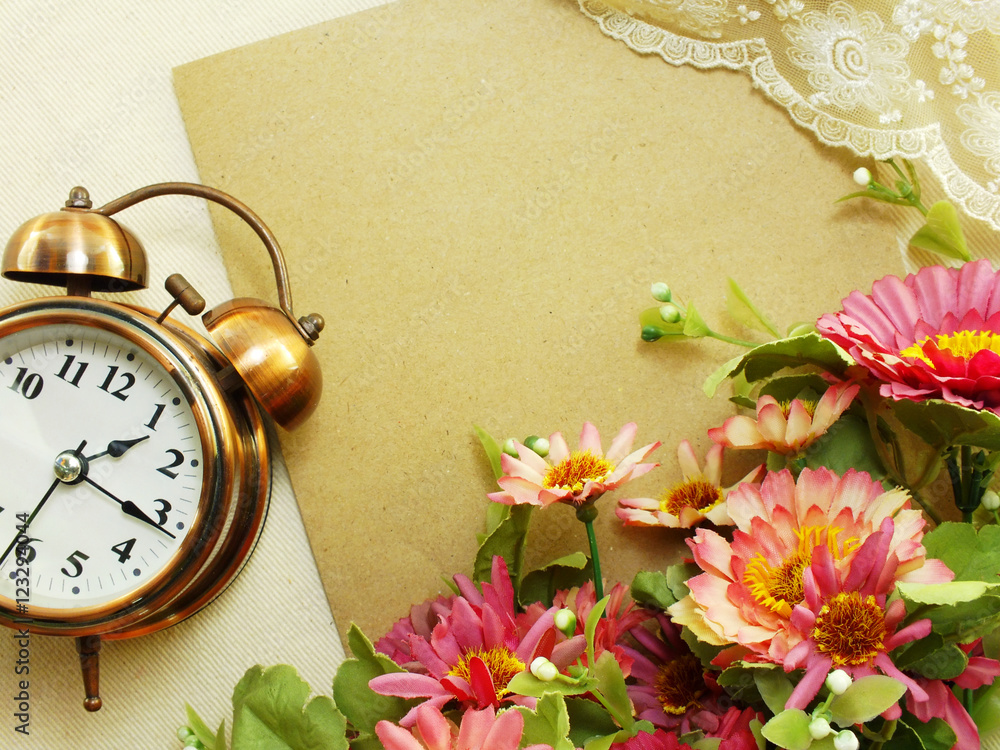 Poster spring time with alarm clock and artificial flowers bouquet background
